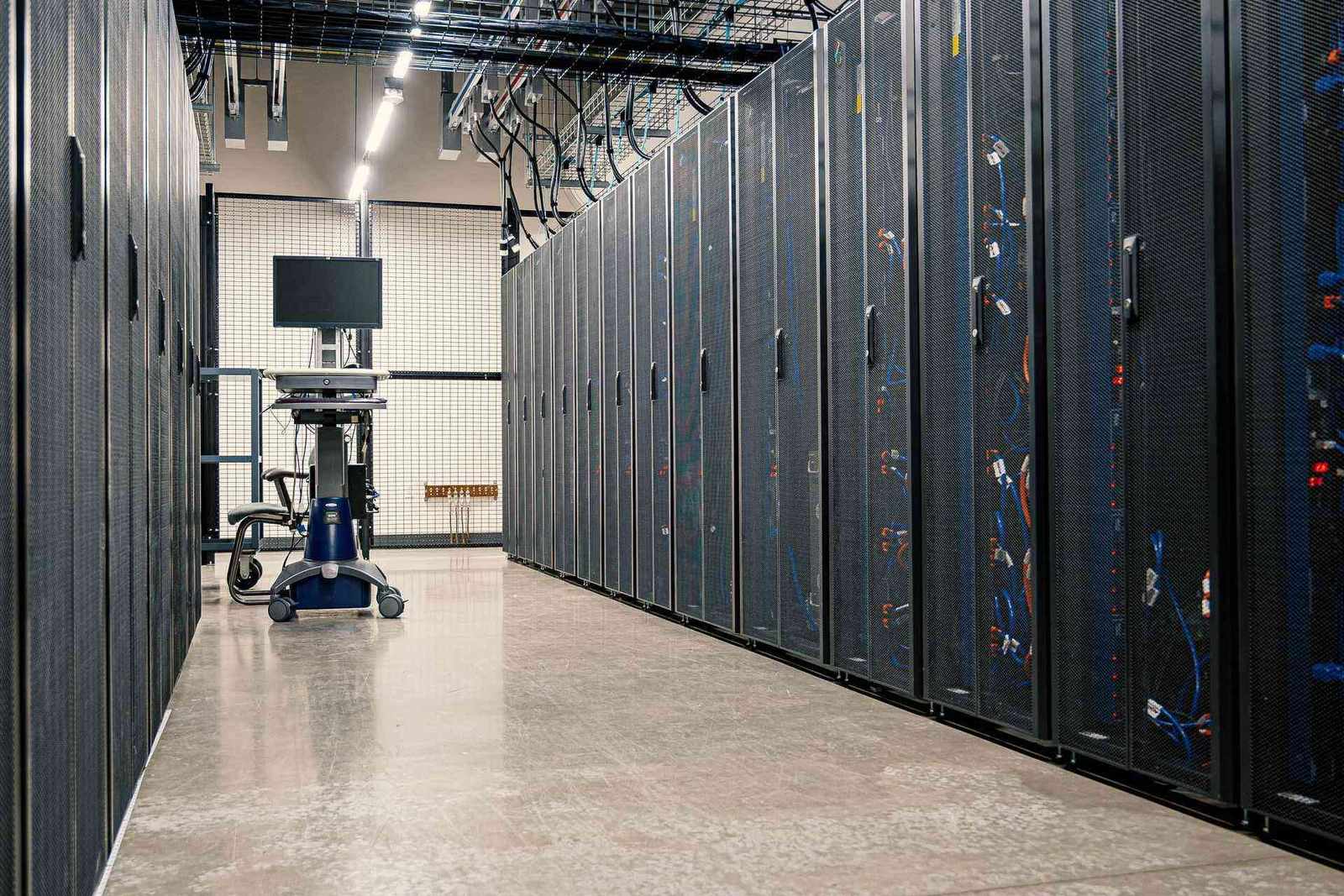 Rows of network servers and patch cables in a data hall